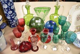 A selection of Art Glass wares including two apple green decanters, fishing floats, ruby candle