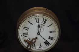 An early 20th century nautical ships clock having brass case with heavy bevel edged glass, including