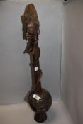 An unusual African tribal wood carved totem of a snake wrapped round female figure 55cm tall approx