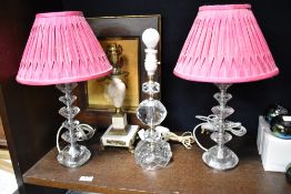 Three mid century kitsch cut glass table lights with a similar onyx and ormolu decorated lamp base.