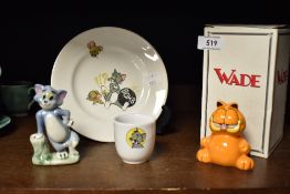 A selection of cartoon items including Garfield and Tom cat Wade figures with a Tom and Jerry egg