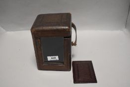 An antique carriage clock case with glass window