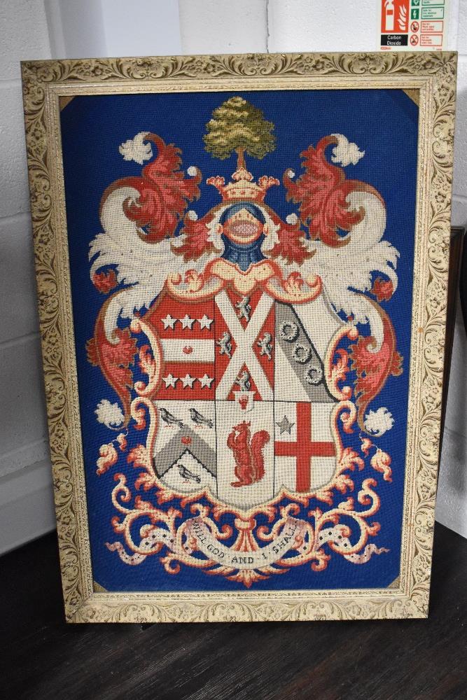 A vintage wool work embroidery of a heraldic crest with motto Will God and I Shall