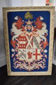 A vintage wool work embroidery of a heraldic crest with motto Will God and I Shall