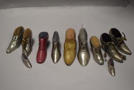 Eleven vintage pin cushions in the form of ladies shoes or boots, most being cast in pewter.