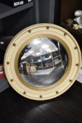 A 1950's nautical themed bulls eye or port hole mirror with convex glass and cream and gilt frame.