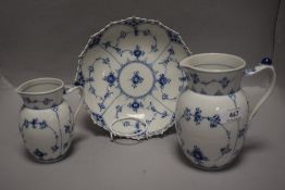 Three peices of modern Royal Copenhagen including two milk jugs and a bowl with pierced edge work.