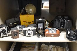 A selection of vintage cameras including Kodak 44B, Duaflex II, Brownie 127, A-120, Halina AF810 and