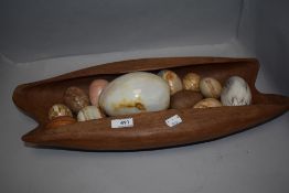 A mid century teak carved wood bowl with enclosed design and a selection of semi precious stone