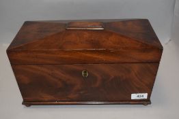 A Victorian tea caddy of casket form with fitted mahogany boxed interior, on brass ball feet with