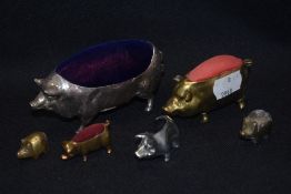 Four pin cushions in the for of farm yard pigs, in cast metals with velvet cushions.