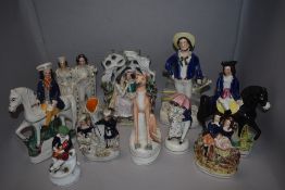 A selection of antique and later Staffordshire flat back figures and studies including Grey Hound,