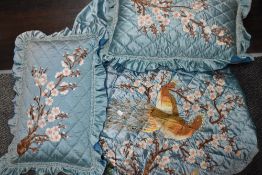 A vintage Chinese satin bedspread and pillow case set having extensive embroidery.