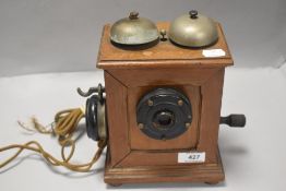 An early 20th century Telephone set or receiver of an unusual design in fitted mahogany case.