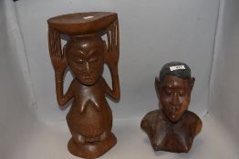 An African tribal wood carved plant stand in the form of a figure and a bust of a female warrior