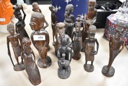 A selection of African tribal wood hand carved figures of villagers and natives.