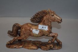 A vintage soap stone carved figure study of a mustang horse