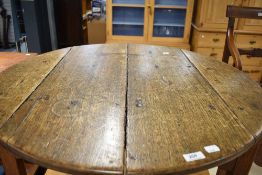 A Period oak cricket table of typical design having shaped apron, circular top diameter approx.