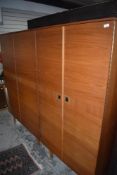 A pair of vintage teak wardobes, labelled Stonehill furniture, recessed handles, fittings to