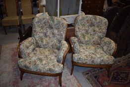 A pair of Ercol mid stain cottage arm chairs