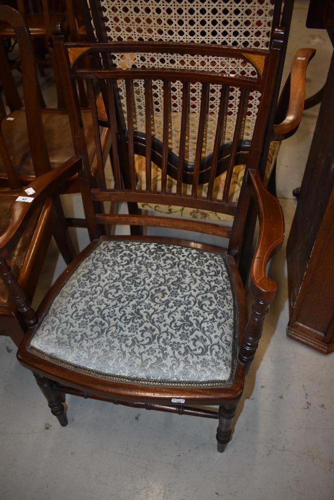 A late 19th or early 20th Century mahogany salon armchair having turned frame and inlay decoration