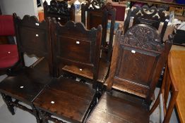 A harlequin set of period oak panelled solid seat chairs