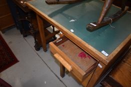 A vintage oak desk of small proportions with single bank of three drawers