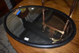 An early 20th Century oval wall mirror