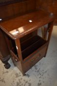 An early 20th Century mahogany side table with magazine rack under
