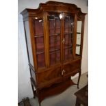 An Edwardian mahogany display cabinet having glazed section and cupboard under with cabriole legs