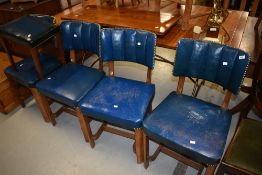 A set of four walnut framed and blue leather dining chairs and a footstool