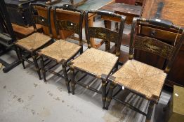 A set of four Victorian Aesthetic style ebonised dining chairs having turned frames and rush seats
