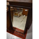 An early 20th Century oak wall mirror