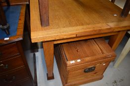 An early to mid 20th Century golden oak drawer leaf dining table