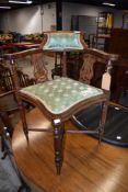 An Edwardian mahogany and inlaid corner chair having lyre supports