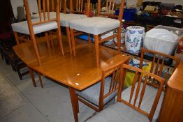 A vintage Gordon Russell dining table and eight chairs