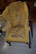A good quality Queen Anne style wingback armchair having floral tapestry upholstery