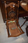 A 19th Century folding campaign style chair having canework seat and inlaid decoration throughout