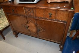 An early 20th Century oak sideboard of compact design