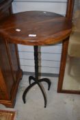 A modern hardwood and wrought iron occasional table , height approx. 81cm, diameter 47cm