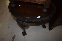 An early 20th Century mahogany coffee table having shaped top and legs, ball and claw feet
