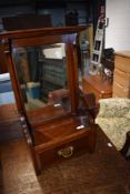 A Victorian mahogany hall mirror with drawer under
