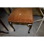 An early 20th Century stained frame stool having upholstered seat