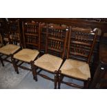 A set of four reproduction rush seated spindle back chairs