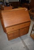 A teak Nathan bureau (key present)