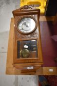 A vintage oak wall clock of small proportions, height 54cm