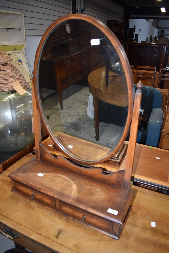 An early 20th Century mahogany toilet mirror having double drawer base