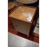 An early to mid 20th Century golden oak pot cupboard