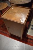 An early to mid 20th Century golden oak pot cupboard