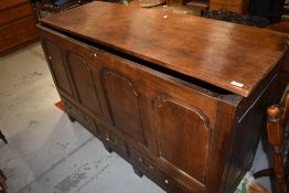 A period oak four panel kist having three drawers to base, with later loose top